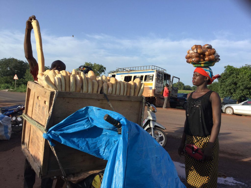 Malian woman carries load on her head