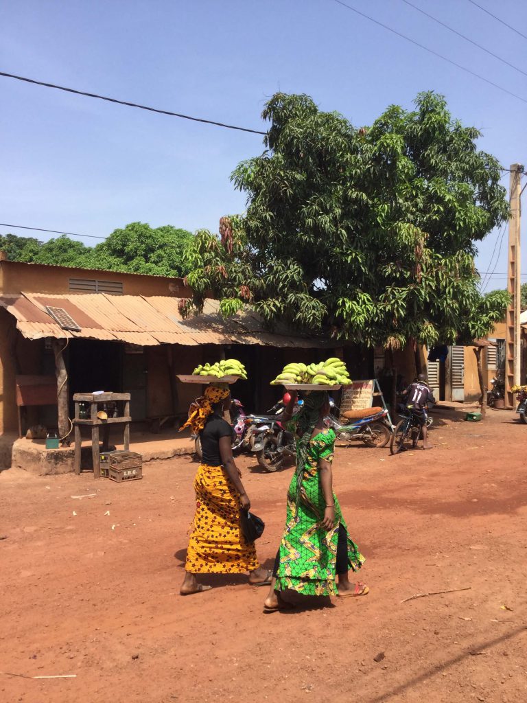 Women carry bananas on their heads to sell in Mali