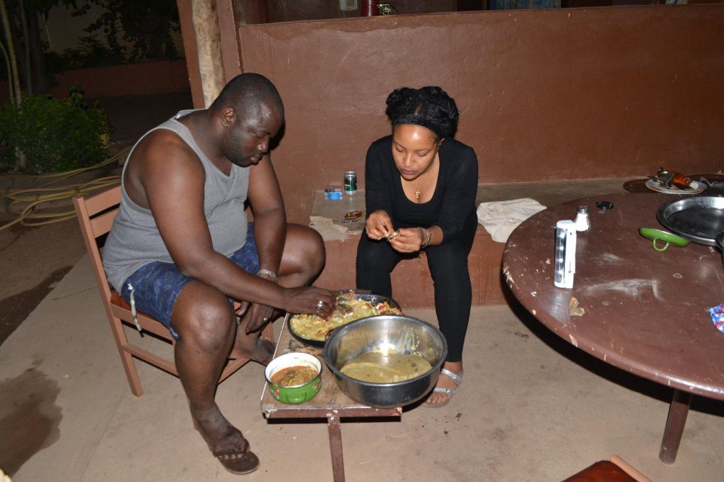 Man and woman eating Malian food