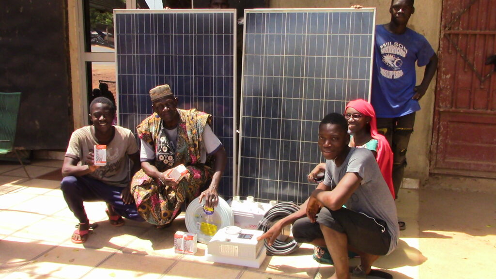 bara and the group around their solar panel gear to improve youth development